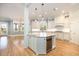 Open kitchen with island, custom cabinets, granite countertops, and stainless steel appliances at 24 Waterway Island Dr, Isle of Palms, SC 29451