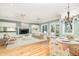 Bright living room with hardwood floors, fireplace, and dining area at 24 Waterway Island Dr, Isle of Palms, SC 29451