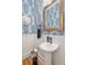 Stylish powder room featuring wallpaper, a modern mirror and sink at 24 Waterway Island Dr, Isle of Palms, SC 29451