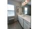 Bright bathroom featuring a white vanity with a large mirror and tiled floors at 251 Summers Dr, Summerville, SC 29485