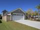 A detached two car garage, white door, gray siding, and a large concrete driveway at 251 Summers Dr, Summerville, SC 29485