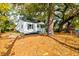 Side view of a cozy home featuring mature trees and a well-maintained yard at 2604 Ferrara Dr, North Charleston, SC 29405