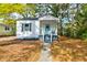 Charming single-story home with a welcoming blue door and beautiful, mature landscaping at 2604 Ferrara Dr, North Charleston, SC 29405