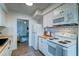 Compact kitchen featuring white appliances, tile backsplash, and wood countertops at 2604 Ferrara Dr, North Charleston, SC 29405