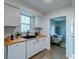 Cozy kitchen featuring white cabinetry, tiled backsplash, and butcher block countertops at 2604 Ferrara Dr, North Charleston, SC 29405