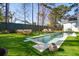 Backyard featuring a pool, lounge furniture, green grass, and tall trees at 307 Shoals Dr, Mount Pleasant, SC 29464