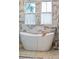 Chic bathroom showcasing a soaking tub and luxurious marble tiling with natural light from adjacent windows at 307 Shoals Dr, Mount Pleasant, SC 29464