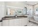 Luxurious Primary bath with double vanity, stylish mirrors, a soaking tub, and a glass-enclosed shower at 307 Shoals Dr, Mount Pleasant, SC 29464