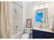 Bright bathroom featuring a shower-tub combo, a dark blue vanity, and updated fixtures at 307 Shoals Dr, Mount Pleasant, SC 29464