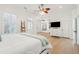 Spacious bedroom with hardwood floors, ceiling fan, access door, and large dresser with television at 307 Shoals Dr, Mount Pleasant, SC 29464