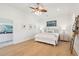 Bright and open bedroom with hardwood floors, a cozy bed, and an ensuite bathroom at 307 Shoals Dr, Mount Pleasant, SC 29464