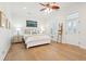Inviting bedroom featuring hardwood floors, white trim, ceiling fan, and a comfortable bed at 307 Shoals Dr, Mount Pleasant, SC 29464