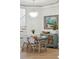 Dining area with a stylish chandelier, staircase, coastal art, and hardwood floors at 307 Shoals Dr, Mount Pleasant, SC 29464