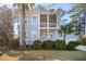 Charming two-story home with a double porch and lush landscaping for enhanced curb appeal at 307 Shoals Dr, Mount Pleasant, SC 29464