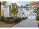 Charming two-story home featuring a screened porch, garage, and lush landscaping at 307 Shoals Dr, Mount Pleasant, SC 29464