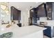 Modern kitchen with navy cabinets, stainless steel appliances, herringbone backsplash, and white countertops at 307 Shoals Dr, Mount Pleasant, SC 29464