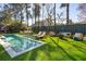 Backyard features a sparkling pool, lounge chairs and green artificial turf at 307 Shoals Dr, Mount Pleasant, SC 29464