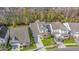 Stunning aerial view of a modern home with manicured lawn and driveway, surrounded by lush greenery at 311 Weston Hall Dr, Summerville, SC 29483