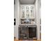 Bar area features a wine refrigerator, display cabinets and a tiled backsplash at 311 Weston Hall Dr, Summerville, SC 29483