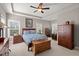 Spacious bedroom with two windows, a ceiling fan, and wooden furniture at 311 Weston Hall Dr, Summerville, SC 29483