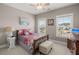 Cozy bedroom features a floral bedspread, ceiling fan, and two windows at 311 Weston Hall Dr, Summerville, SC 29483