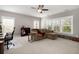 Spacious bonus room with a ceiling fan, tan sofa, and plenty of natural light at 311 Weston Hall Dr, Summerville, SC 29483