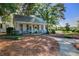Charming cottage with rocking chairs on the porch, part of the Shady Oak Cottage Coffee House at 311 Weston Hall Dr, Summerville, SC 29483
