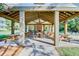 Spacious covered patio with ample seating and tables for dining, as well as an indoor fireplace at 311 Weston Hall Dr, Summerville, SC 29483