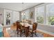 Well-lit dining area with hardwood floors, a decorative rug and three large windows at 311 Weston Hall Dr, Summerville, SC 29483