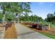 Picturesque community entrance featuring a stone archway, decorative landscaping, and signage for The Farm neighborhood at 311 Weston Hall Dr, Summerville, SC 29483