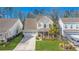 Charming two-story home with a well-manicured lawn and a welcoming front porch in a suburban neighborhood at 311 Weston Hall Dr, Summerville, SC 29483