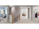 Neutral hallway showcases entrances to the laundry room and a living room at 311 Weston Hall Dr, Summerville, SC 29483