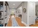 Spacious hallway with hardwood floors, neutral walls, and decorative accents leading to other rooms at 311 Weston Hall Dr, Summerville, SC 29483