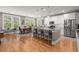 Open kitchen with stainless steel appliances, granite countertops, island seating, and a dining area at 311 Weston Hall Dr, Summerville, SC 29483