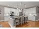 Bright, modern kitchen with white cabinets, stainless appliances, island seating, and granite countertops at 311 Weston Hall Dr, Summerville, SC 29483