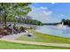 Beautiful lakefront area with sculptures, a paved walkway, and a tranquil fountain, ideal for relaxation at 311 Weston Hall Dr, Summerville, SC 29483