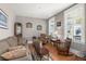 Cozy living room with neutral tones, wood floors, and natural light streaming through the windows at 311 Weston Hall Dr, Summerville, SC 29483