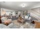 Open-concept living room with wood floors, comfortable seating, adjacent to the kitchen and dining area at 311 Weston Hall Dr, Summerville, SC 29483