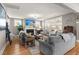 Bright living room offers large windows, a cozy fireplace, a ceiling fan and hardwood floors at 311 Weston Hall Dr, Summerville, SC 29483