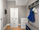 Mud room includes cabinet storage, wood floors and a bench with hat racks and shoe storage at 311 Weston Hall Dr, Summerville, SC 29483