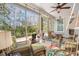 Relax on this screened in porch with wicker furniture and views of the backyard at 311 Weston Hall Dr, Summerville, SC 29483