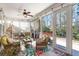 Relax on this screened-in porch with wicker seating, ceiling fan and views of the patio and backyard at 311 Weston Hall Dr, Summerville, SC 29483
