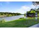 Picturesque view of Village Pond with a sign, serene water, and lush greenery on a sunny day at 311 Weston Hall Dr, Summerville, SC 29483
