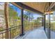 Relax on the large balcony with dark posts and railings and views of the water in the distance at 3121 Marshgate Dr, Johns Island, SC 29455