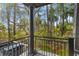 Private balcony with wrought iron railings overlooks lush trees and foliage at 3121 Marshgate Dr, Johns Island, SC 29455