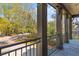 Enjoy the neighborhood from this covered balcony with dark columns, decorative railings, and a wood-plank floor at 3121 Marshgate Dr, Johns Island, SC 29455