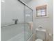 This bathroom features a tiled shower and tub with sleek glass doors and a window at 3121 Marshgate Dr, Johns Island, SC 29455