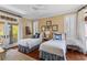 Inviting bedroom featuring two beds with plush pillows, matching decor, and access to a private balcony at 3121 Marshgate Dr, Johns Island, SC 29455