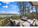 Inviting outdoor deck with a cozy seating area, wood flooring, and scenic views of the waterfront at 3121 Marshgate Dr, Johns Island, SC 29455