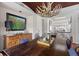 A spacious dining area showcasing a large wooden table with seating and an antler chandelier for a rustic touch at 3121 Marshgate Dr, Johns Island, SC 29455